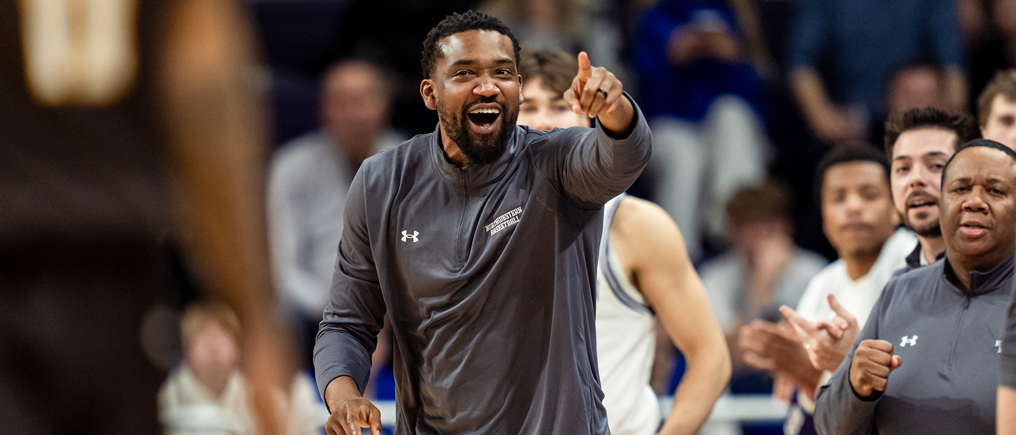 20251216_MBB_Valpo_MGG_176.JPG Northwestern assistant coach Shane Southwell stands on the bench and points to the court.