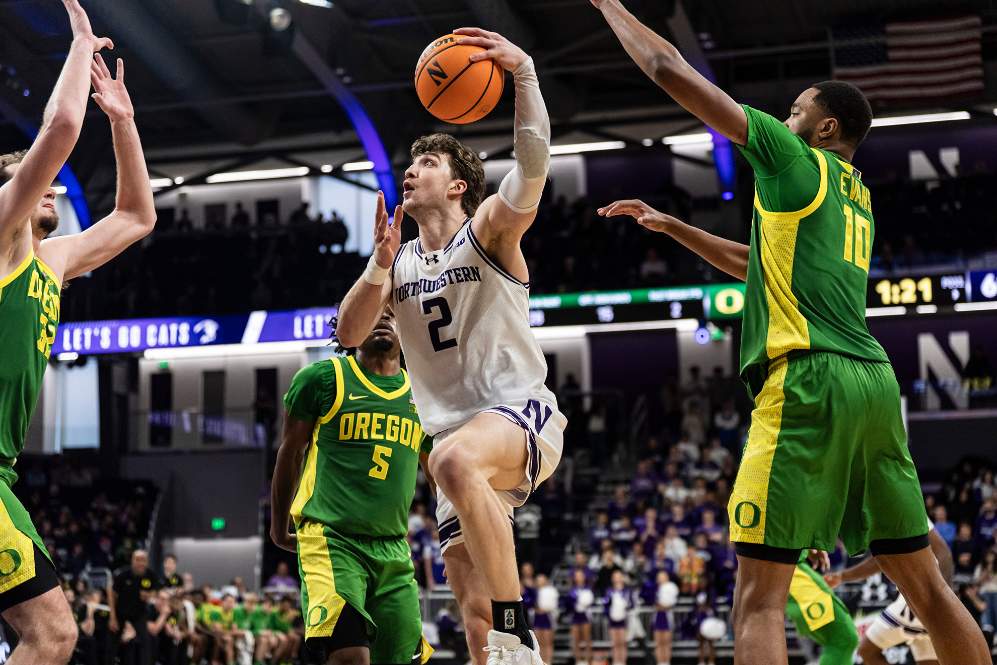 Northwestern's Nick Martinelli drives for a layup against Oregon.